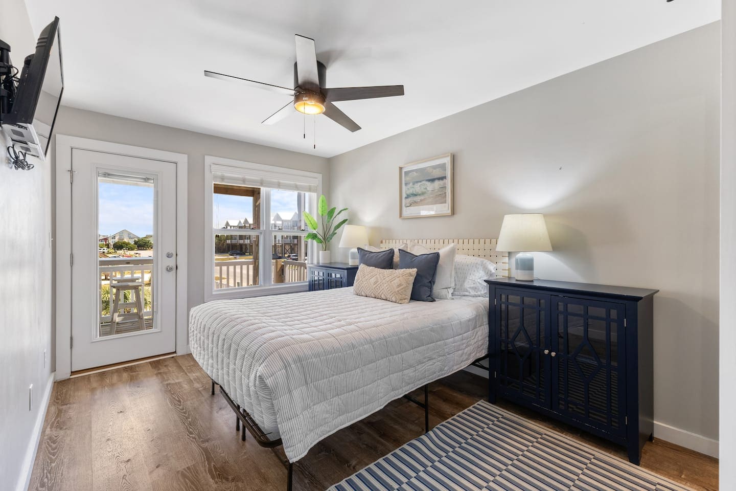 Guest bedroom with navy cabinets and deck view