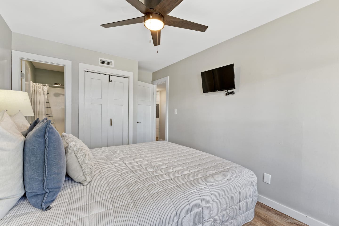 Bedroom with coastal blue pillows and ensuite access