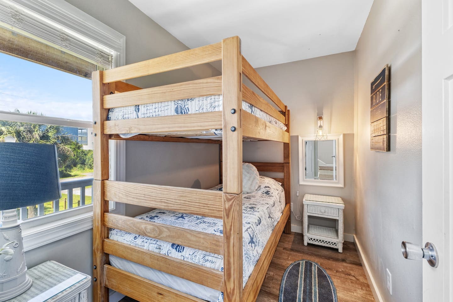 Kids bunk room with nautical prints and Ride the Wave sign