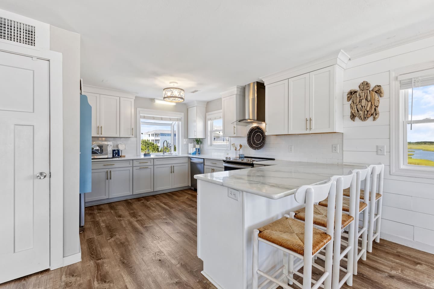 Coastal kitchen with white and gray cabinets and marsh view