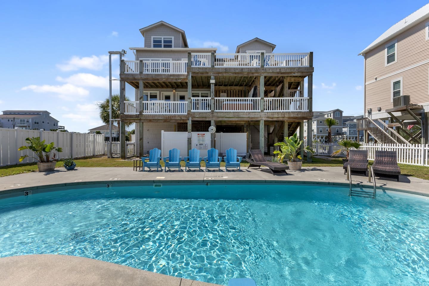 Private pool and rear decks of Topsail Paradise under a clear blue sky