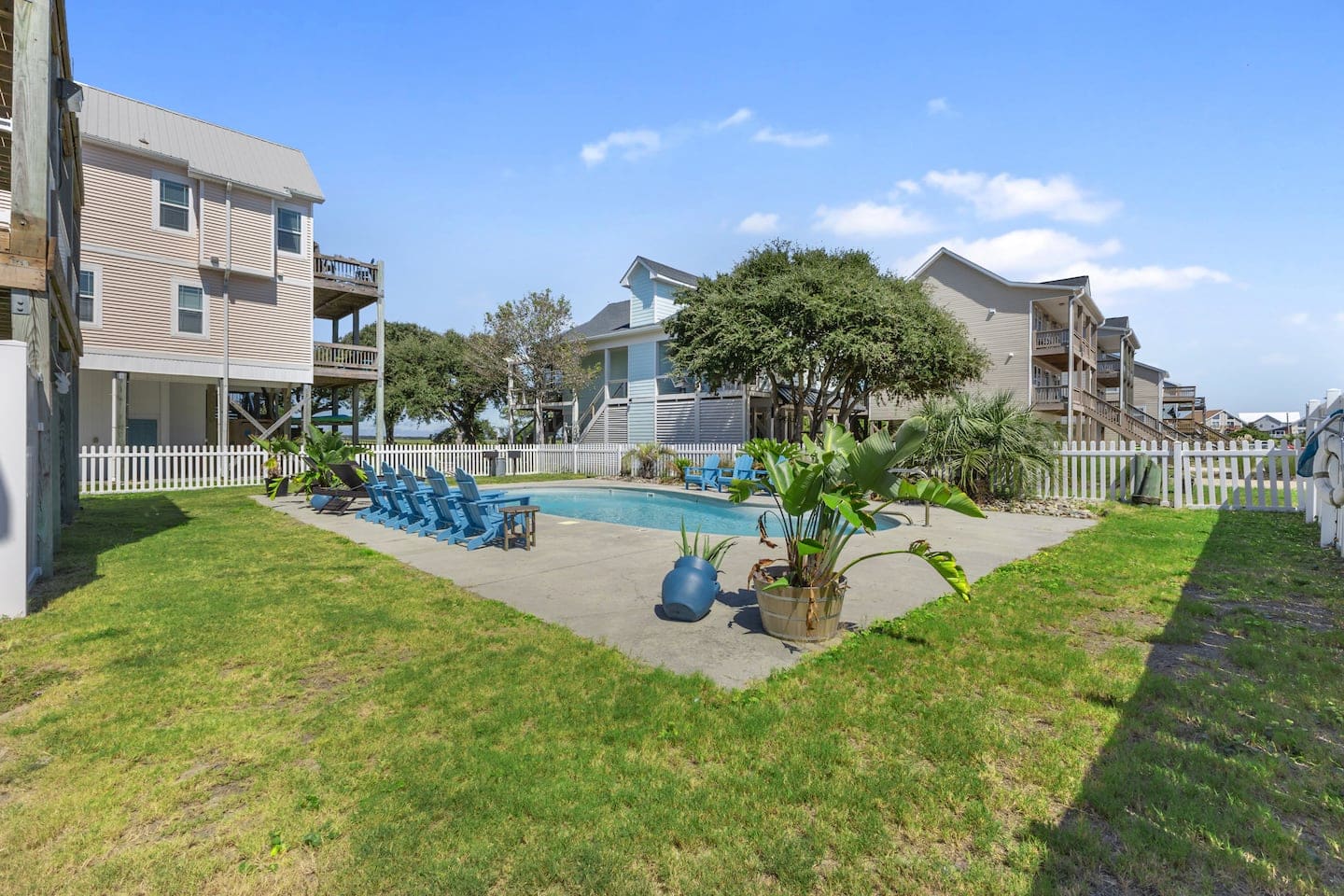 Pool deck lined with sky-blue lounge chairs