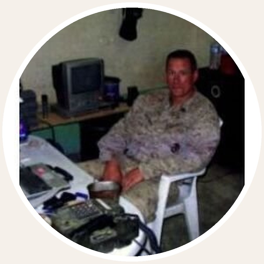 Gunnery Sergeant Darrell W. Boatman seated in desert utility uniform