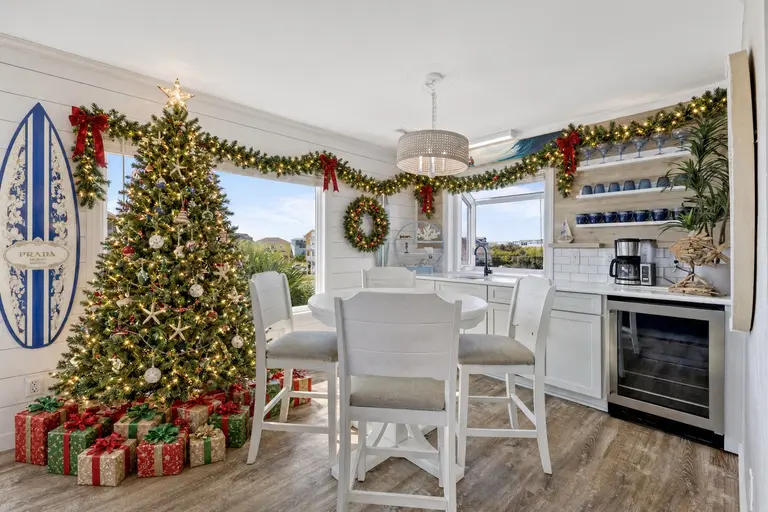 Christmas tree with wrapped gifts and lit garland in the bar nook at Topsail Paradise, a Topsail Island holiday rental