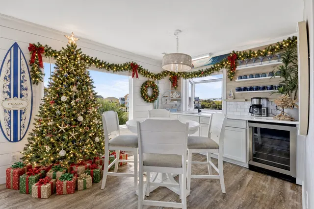 Topsail Paradise breakfast nook decorated for Christmas with a tree, gifts and garland