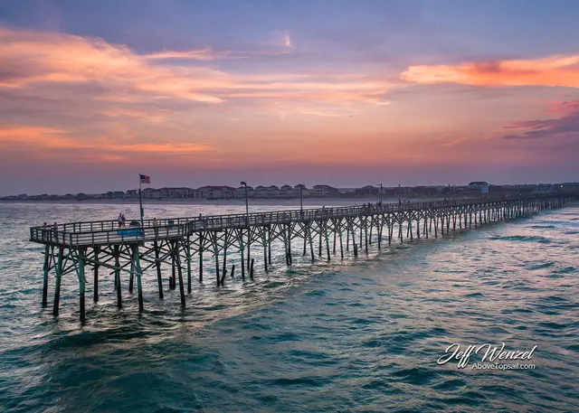 Aerial view of a Topsail Island fishing pier at sunset