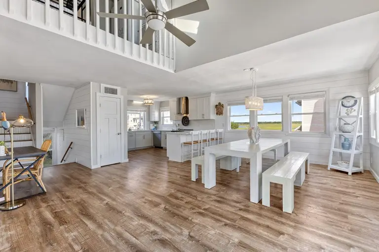 Open dining table with benches overlooking the marsh at Topsail Paradise