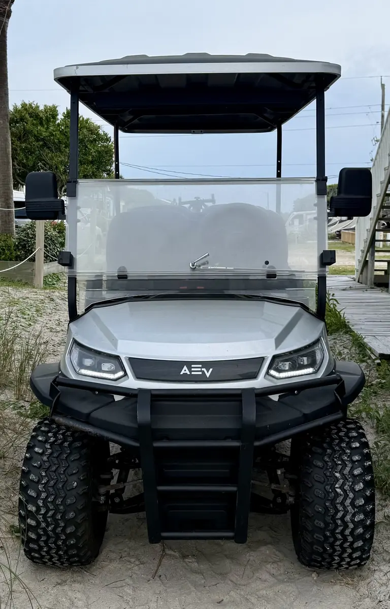The 6-passenger electric golf cart parked on the sandy path at Topsail Paradise, North Topsail Beach
