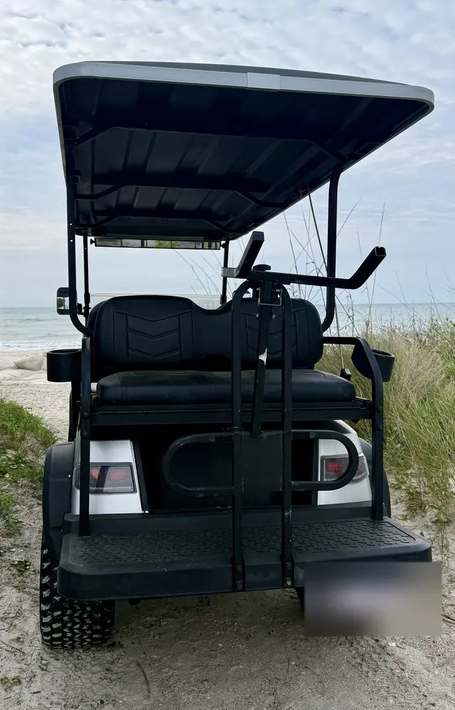 Rear of the golf cart with a rack for beach chairs