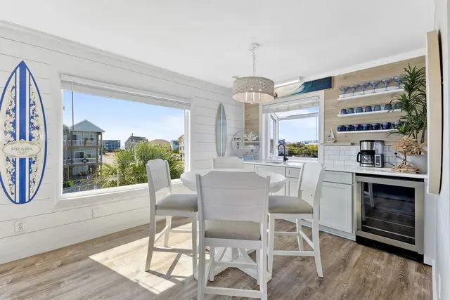 Wet bar with coffee maker, wine fridge, and a table for four